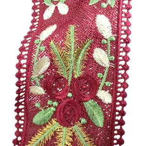 Close-up of red mesh lace collar with intricate floral and leaf embroidery details.