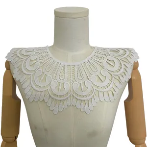 Detailed view of a white milk silk embroidered lace faux collar on a mannequin torso.