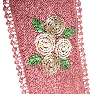 Close-up detail of pink embroidered lace collar piece with floral motifs