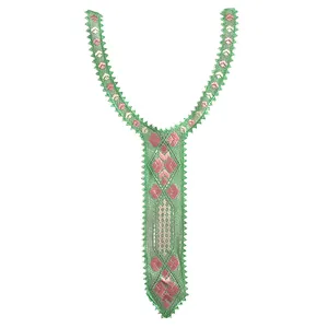 Detailed view of a green embroidered lace collar patch with pink geometric patterns