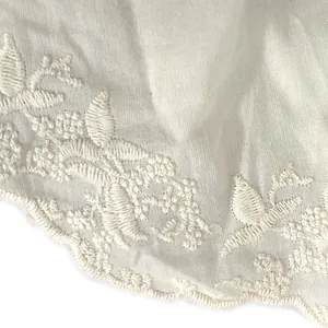 Detailed view of intricate white floral embroidery on cotton lace doll collar accessory