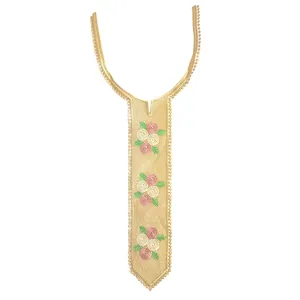 Close-up detail of a golden tie-shaped lace collar patch with floral rose embroidery