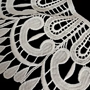 Close-up of white milk silk water-soluble embroidery lace collar with intricate pattern
