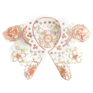 Detail view of intricate pink and yellow sakura embroidery on organza collar