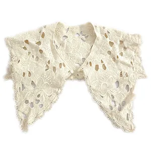 Detailed close-up of hollow floral embroidery on a white cotton lace fake collar