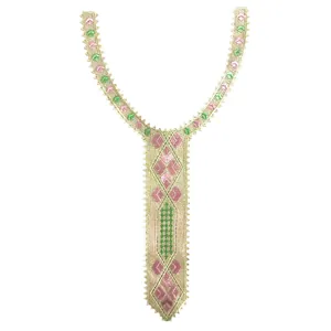 Detailed view of gold embroidered lace collar with elegant pink and green patterns