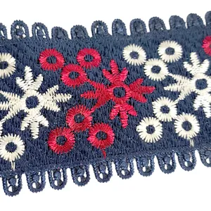 Close-up of heavy floral embroidery on dark blue lace trim for garment decoration.