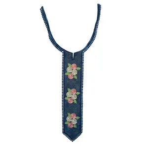 Macro detail view showing rose floral embroidery on navy blue lace neck collar.