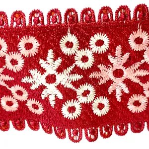 Close-up of red lace collar featuring intricate white and pink floral embroidery