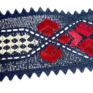 Detailed macro view of red and beige ethnic embroidery on black mesh lace collar