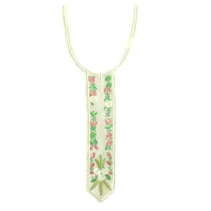 Close-up of colorful floral embroidery on a white lace tie-shaped faux collar piece.
