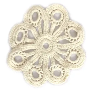 Detailed view of a beige crochet lace flower patch with intricate stitch patterns.