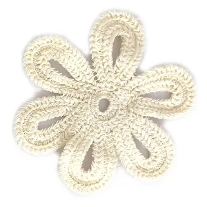 Detailed close-up of white crocheted lace flower patch with hollow six-petal design