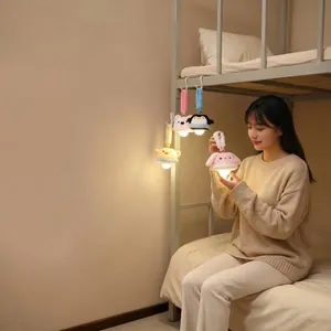 Cozy dormitory scene with various cute plush animal night lights hanging on a bunk bed