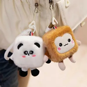 Adorable square panda and bread toast plush keychain charms hanging on a bag strap