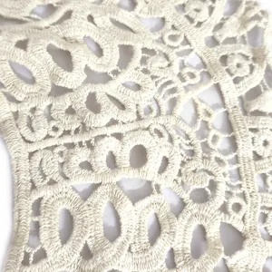 Detailed macro view of off-white milk silk embroidery lace collar with hollow pattern