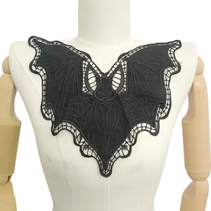 Detailed view of gothic black bat lace embroidered collar on white mannequin