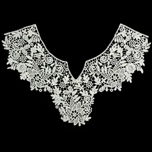 Detailed view of intricate white milk silk floral embroidery lace collar on black background
