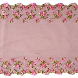 Close-up macro detail of pink floral embroidery on delicate mesh lace trim fabric