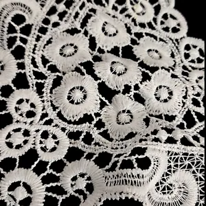 Close-up of white milk silk embroidery lace with delicate hollowed-out flower pattern