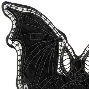 Macro detail of black bat embroidered lace showing intricate stitching and hollow pattern