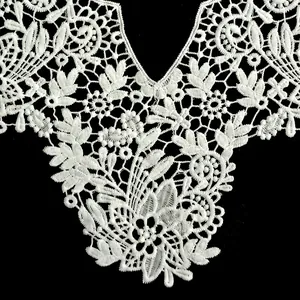 Detailed macro shot of milk silk embroidered white lace floral collar applique