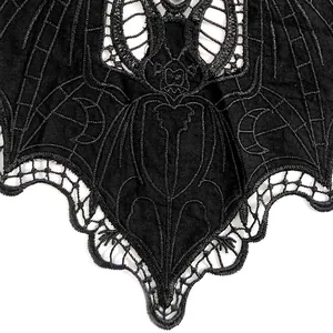 Macro view of black bat embroidery lace patch with intricate hollow-out gothic details