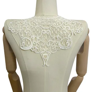 Close-up view of intricate white milk silk embroidered lace collar applique on mannequin torso