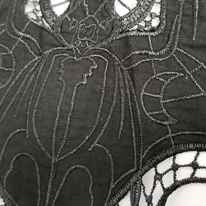 Close-up of black bat embroidery lace patch with intricate hollow design details.