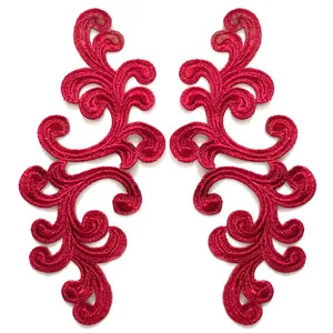 Close-up of symmetrical red embroidered lace floral patches for DIY sewing projects