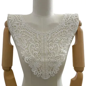 Detailed view of intricate white hollow out floral embroidery lace collar on torso.