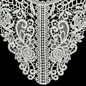 Intricate white water-soluble lace embroidery detail showing hollow-out floral patterns.