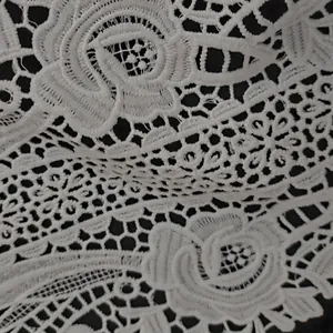 Macro view showing intricate details of white milk silk embroidered lace floral collar