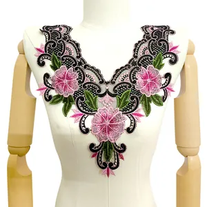 Detail view of pink and black floral embroidered lace collar applique on mannequin