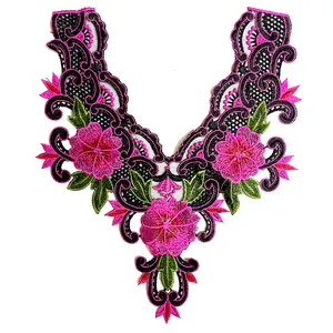 Close-up of pink floral embroidery lace collar on black mesh fabric background
