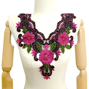 Detailed macro view of pink floral embroidery on a heavy-duty mesh lace collar