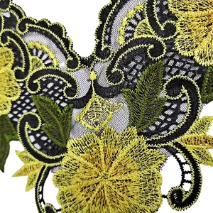 Close-up detail of heavy embroidered floral lace patch with yellow and black stitching