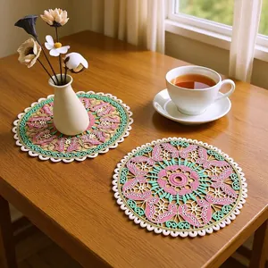 Detailed view of colorful butterfly embroidered lace placemats on a wooden table