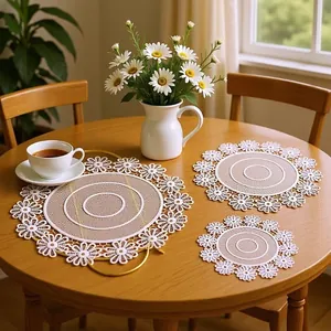 Detailed view of round lace embroidered placemats with hollow floral borders on a table