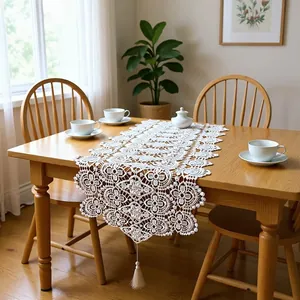Elegant white lace hollow-out table runner featuring 3D floral embroidery and tassels.