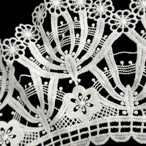 Close-up detail of white milk silk embroidered lace collar with hollow out floral pattern