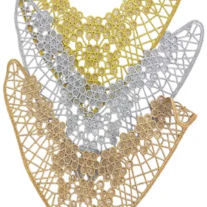 Macro detail of metallic gold and silver embroidered hollow-out lace flower patches for shoes