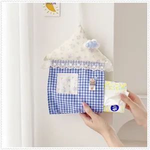 Cute house-shaped fabric tissue holder hanging bag being used with a tissue pack