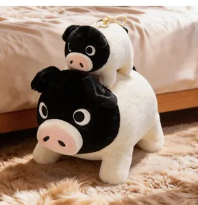Macro view of cute black-faced plush pig toys including a plushie and a keychain