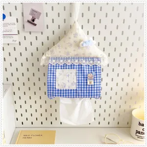 Close-up of cute house shaped hanging tissue holder with lace and cloud detail
