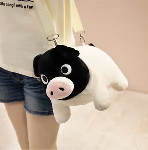 Close-up of a cute black and white plush pig crossbody bag worn by a model in detail
