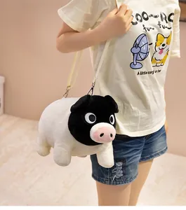 Detail shot of a cute black-faced pig plush crossbody bag worn by a model.