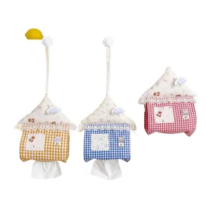 Three cute house-shaped hanging tissue covers in colorful gingham and floral patterns.