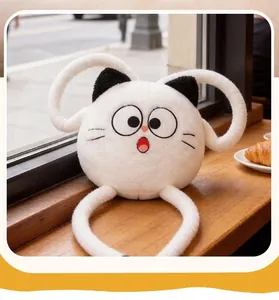 Macro view of a funny white cat plush pillow with soft fur texture in a cozy cafe