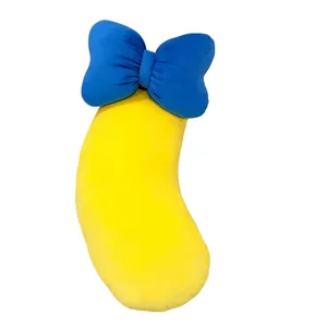 Oreiller en peluche banane avec gros nœud bleu pour un soutien confortable au lit